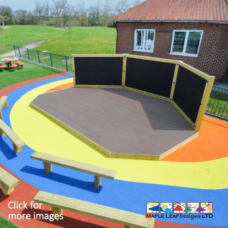 The Triple Chalkboard & Stage is a 6.6m x 4m Stage, with 2no chamfered front corners. This Stage is also perfectly matched with 3no 2.4m x 1.2m Magnet Compatible Chalkboards. Larger than our Single and Double, options, the Triple Chalkboard & Stage provides children with a larger area for performances and lessons. This creates a fantastic focal point in the playground, providing children with a dedicated area for exciting outdoor learning. The Triple Chalkboard & Stage is sure to engage imaginative play and promote creativity, with a space to perform plays, musicals, dance routines and drama performances in front of their peers and teachers. Take the classroom outside and into the playground, where dancing, acting, singing, performing and storytelling will have a dedicated area. This is a great way to introduce children to learning outdoors, allowing children and teachers alike to participate in outdoor teaching, reading and role-play activities. Stages are perfect for building confidence, encouraging an interest in theatre, public speaking and teamwork. Depicted in the first image, you can see our Triple Chalkboard & Stage surrounded by Timber Bench Seating and a colourful Wetpour surfacing.