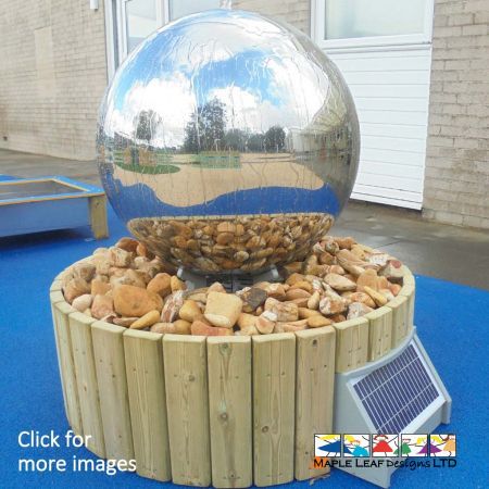 The Stainless Steel Sphere Water Feature consists of a 0.75m wide stainless steel sphere with reservoir base 0.95m surrounded by cobbles. This water feature is powered by solar energy. Not only is this Water Feature an eye-catching focal point within the playground, it is also suitable for Natural Play areas, as well as Sand and Water Play areas.  The Benefits of a Water Feature Introduce children to a new texture with the Steel Sphere Water Feature, a sensation that is both rewarding and stimulating through touch. The solar powered water pump allows water to trickle over the surface of the sphere, which children can then touch and play with. 