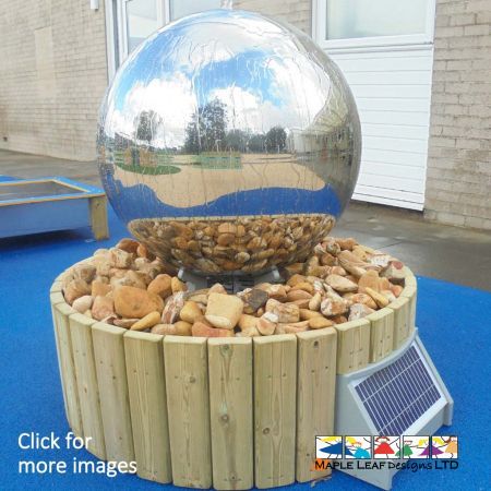 The Stainless Steel Sphere Water Feature consists of a 0.75m wide stainless steel sphere with reservoir base 0.95m surrounded by cobbles. This water feature is powered by solar energy. Not only is this Water Feature an eye-catching focal point within the playground, it is also suitable for Natural Play areas, as well as Sand and Water Play areas.  The Benefits of a Water Feature Introduce children to a new texture with the Steel Sphere Water Feature, a sensation that is both rewarding and stimulating through touch. The solar powered water pump allows water to trickle over the surface of the sphere, which children can then touch and play with.