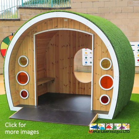 Much like our standard Hobbit House, our Inclusive Hobbit House is constructed from timber and highly durable plastics, ensuring hours of endless fun for years to come! Due to the wide entrance and handy ramp, this item is accessible for children with both manual and motorised wheelchairs. One internal side has a timber bench seat, the other has room for wheelchair parking - allowing children of mixed abilities to enjoy the den together.  The rear side is fitted with a large, clear, polycarbonate window for observation fun. The front walls have built-in colourful porthole windows.  Around the outside, the Inclusive Hobbit House is covered in Artificial Grass. This provides  children with an interesting tactile finish to encourage sensory play! Why choose the Inclusive Hobbit House? Our Inclusive Hobbit House has been designed specifically to encourage children of mixed abilities to play together. Whether it is installed within a school or public space, children will find enjoyment from imaginative play stimulated by the den design.  Inside of the Inclusive Hobbit House, there is space for everyone. This offers children a sense of participation and acceptance, raising the level of interaction in the playground and promoting social-emotional, sensory and cognitive skills.